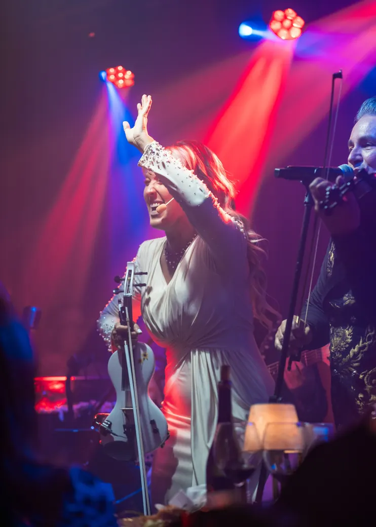 Tania lifting her bow on stage